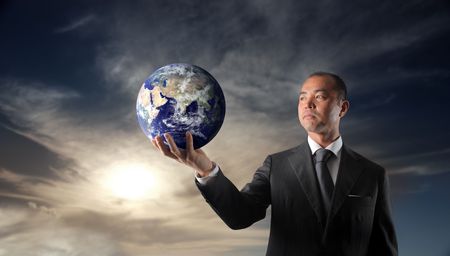 Japanese businessman holding a globeの写真素材