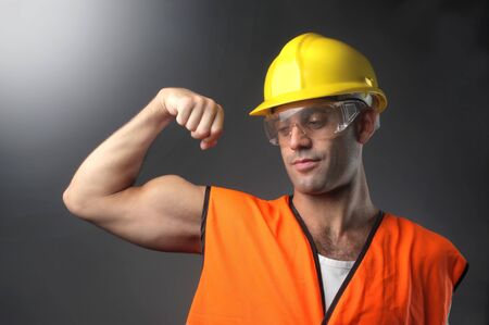 portrait of a worker showing bicepの写真素材