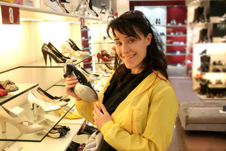pretty girl buying a pair of shoesの写真素材