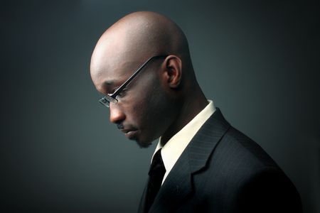 profile of african businessman with sad expressionの写真素材