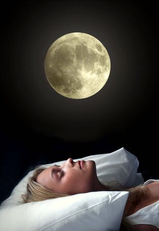 beautiful girl sleeping under the moonlightの写真素材