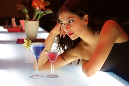 portrait of a young woman in a cocktail bar の写真素材