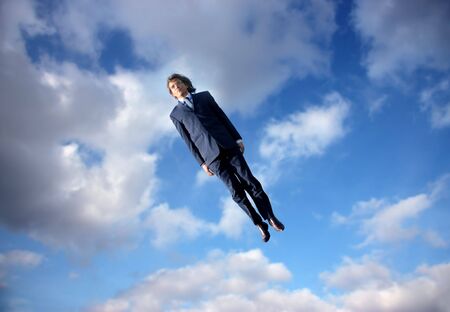 business man flying in the sky の写真素材