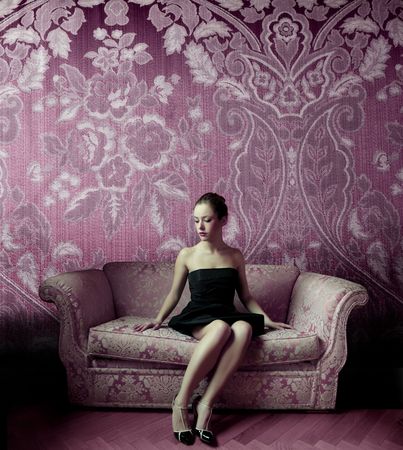 Beautiful woman sitting on a sofaの写真素材