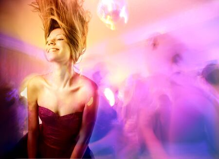 Smiling beautiful woman dancing in a discoの写真素材