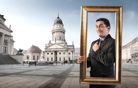 Smiling man in a frame with museum on the backgroundの写真素材