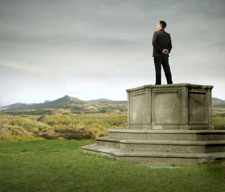 Businessman standing on a pedestalの写真素材