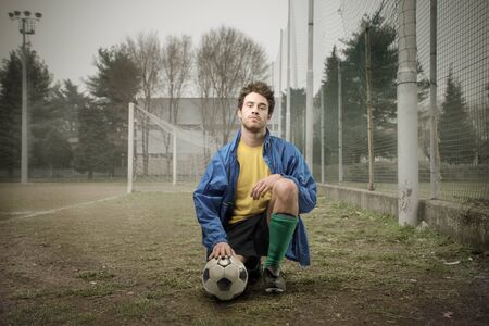 Football player kneeling on a courtの写真素材