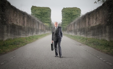 Senior businessman walking on a streetの写真素材