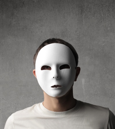 Young man wearing a white Carnival maskの写真素材