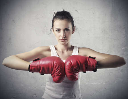 Beautiful woman wearing boxing gloves