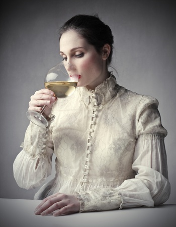 Beautiful woman drinking a glass of wineの写真素材