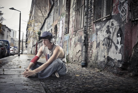 Young man sitting on a city street