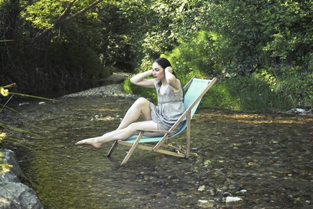 Beautiful woman refrshing in a riverの写真素材