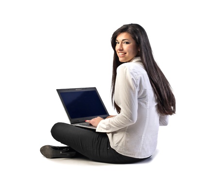 Smiling beautiful businesswoman using a laptopの写真素材