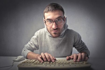 Young man typing on a computer keyboardの写真素材