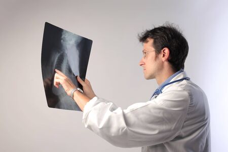 Doctor examining some x-ray slides