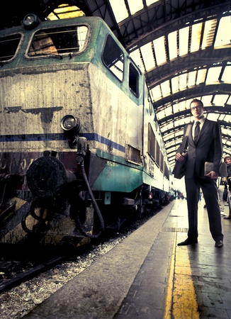 Businessman standing on a platform beside a trainの写真素材