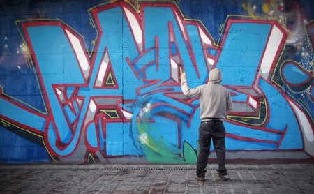 Young man drawing a graffitiの写真素材