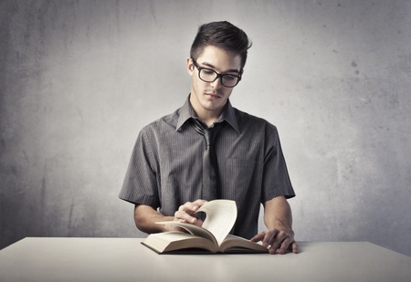 Young man reading a bookの写真素材