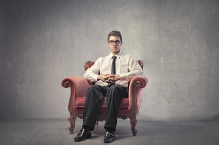 Young businessman sitting on an armchairの写真素材