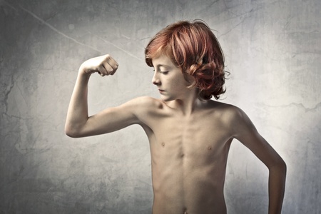 Child showing his muscles