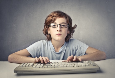 Child typing on a computer keyboardの写真素材