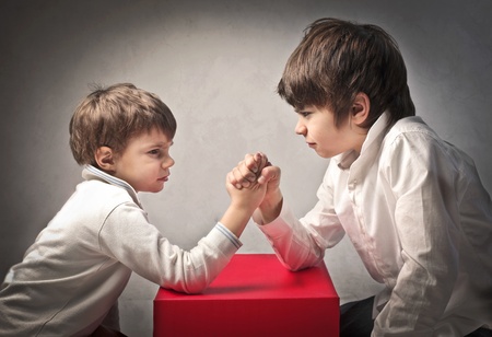 Two brothers playing arm wrestling