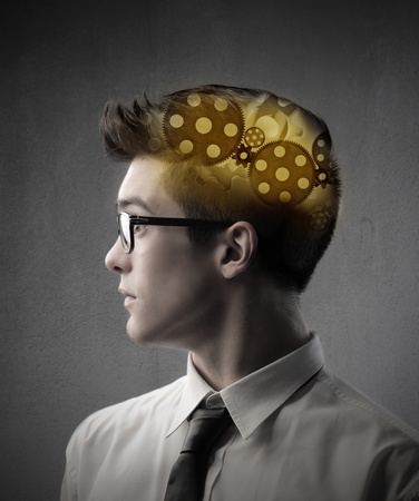 Businessman with gears in his headの写真素材