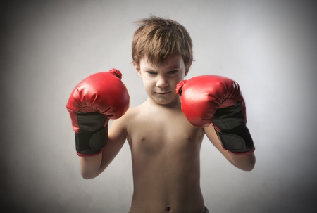 Aggressive child wearing boxing glovesの写真素材
