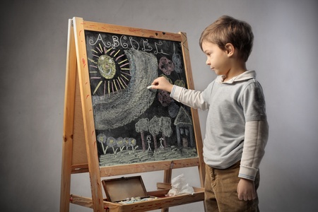 Child writing on a blackboard