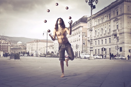 Young man juggling on a city streetの写真素材