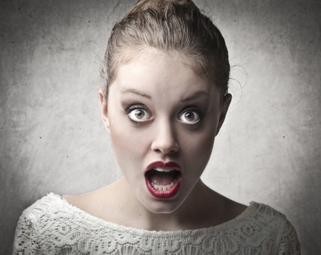 Beautiful woman with astonished expressionの写真素材