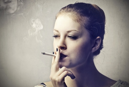 Beautiful woman smoking a cigaretteの写真素材