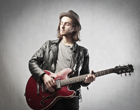 Young man playing the guitarの写真素材