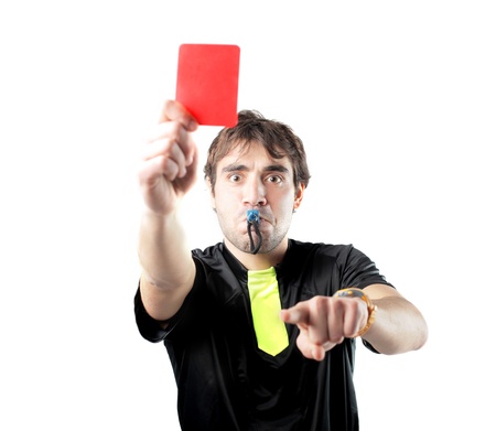 Isolated referee whistling and raising a red cardの写真素材