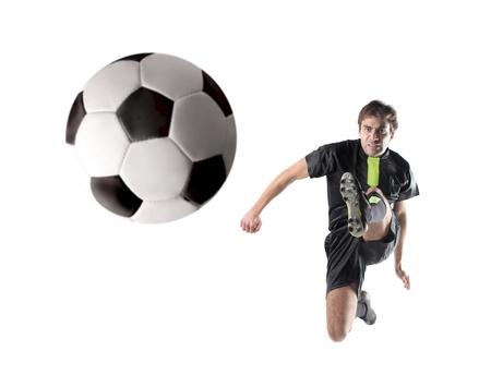 Isolated soccer player shooting a footballの写真素材