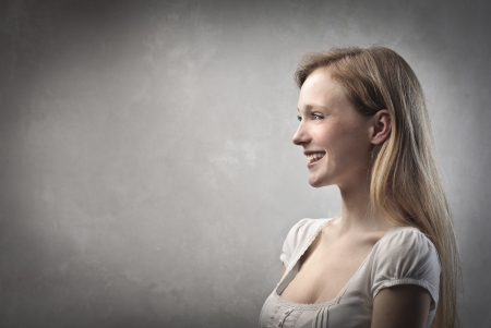 Profile of a smiling beautiful young womanの写真素材