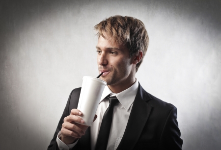 Young businessman having a drinkの写真素材