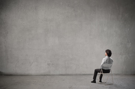 Businessman admiring a white wallの写真素材