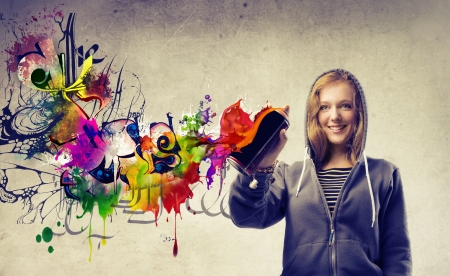 Beautiful blonde girl making a graffitiの写真素材