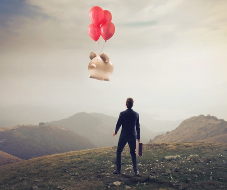 Businessman seeing a piggy flying awayの写真素材