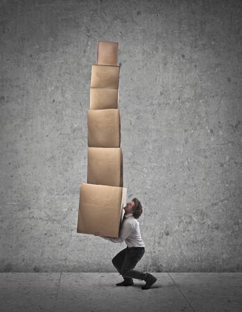 Businessman holding some boxesの写真素材
