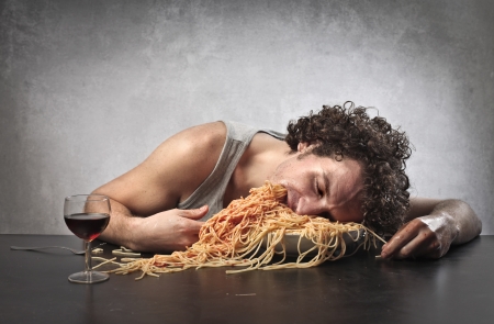 Man passed out from eating too much spaghettiの写真素材