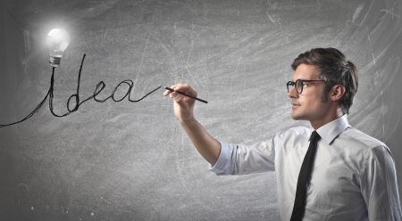 Businessman writing idea on a white wallの写真素材