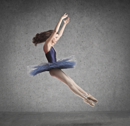 beautiful dancer in blue tutu on gray backgroundの写真素材