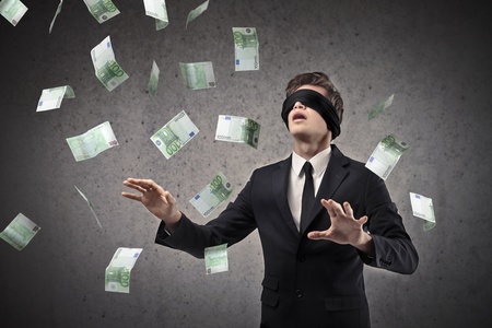 blindfolded businessman looking for moneyの写真素材