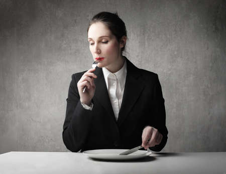 young businesswoman eating の写真素材