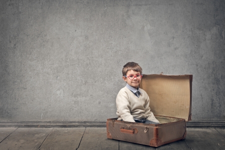 little child in a vintage suitcase