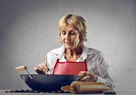 elder woman cookingの写真素材